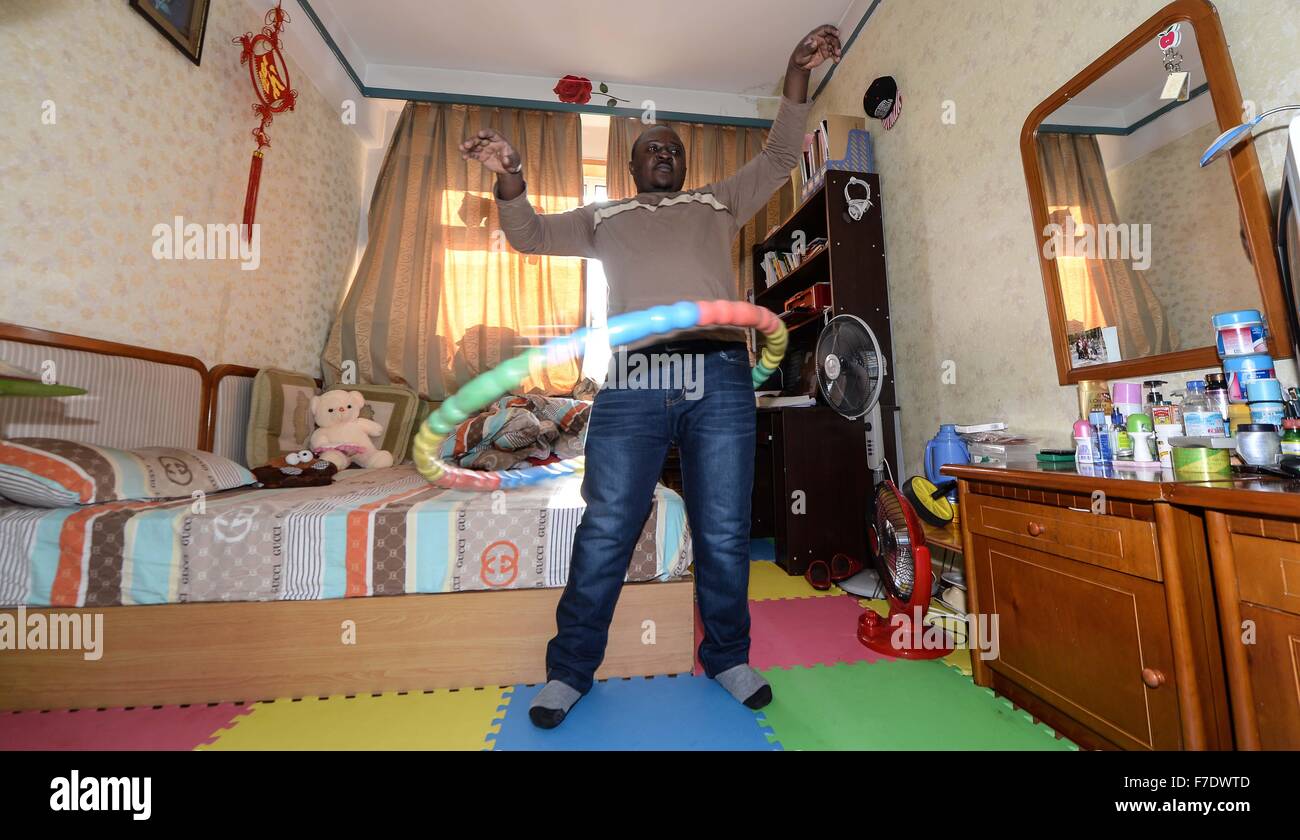 Changchun, China's Jilin Province. 27th Nov, 2015. Ramazani Nashiri, a medical student from Burundi, exercises at his dorm room in Changchun, capital of northeast China's Jilin Province, Nov. 27, 2015. Nashiri, 40, has lived in China for nine years to study gynecology and obstetrics. He now is a PhD student at the Norman Bethune Health Science Center of Jilin University. A total of 528 foreign students studied medicine at the center, most of whom come from Asia and African nations. © Wang Haofei/Xinhua/Alamy Live News Stock Photo