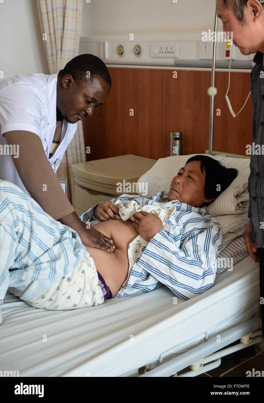 Changchun, China's Jilin Province. 27th Nov, 2015. Ramazani Nashiri (1st L), a medical student from Burundi, gives medical check for a patient at the First Hospital of Jilin University in Changchun, capital of northeast China's Jilin Province, Nov. 27, 2015. Nashiri, 40, has lived in China for nine years to study gynecology and obstetrics. He now is a PhD student at the Norman Bethune Health Science Center of Jilin University. A total of 528 foreign students studied medicine at the center, most of whom come from Asia and African nations. © Wang Haofei/Xinhua/Alamy Live News Stock Photo