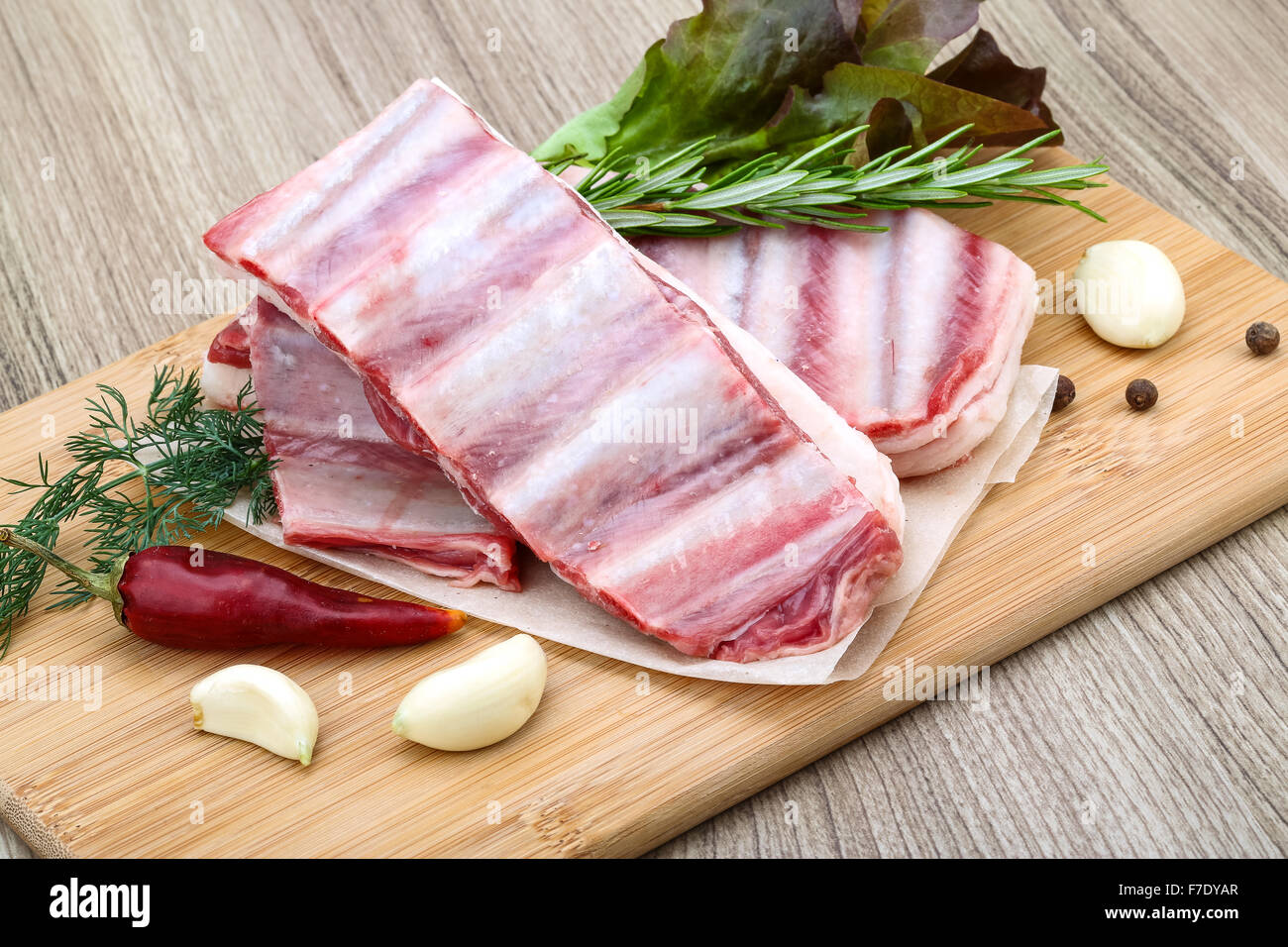 Fresh cold Raw lamb ribs with garlik and pepper - ready for cooking ...
