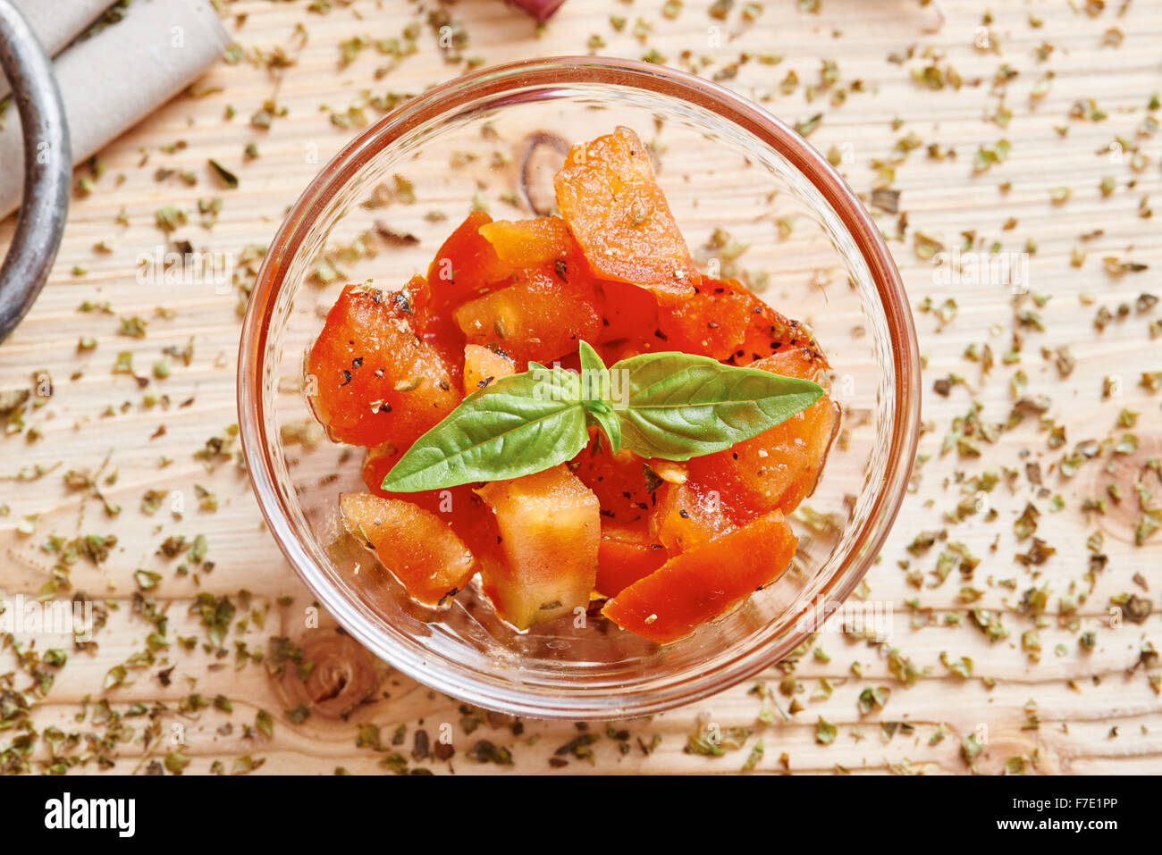 Chopped tomatoes in bowl with basil isolated Stock Photo