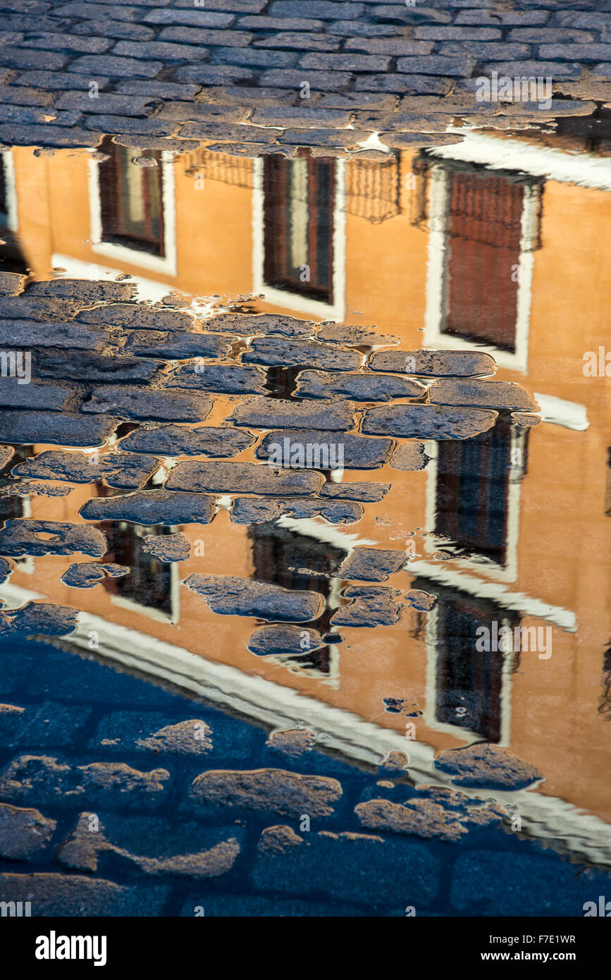 Apartments buildings reflected in a puddle in the Plaza de la Villa, Madrid de los Austrias,  central Madrid, Spain. Stock Photo