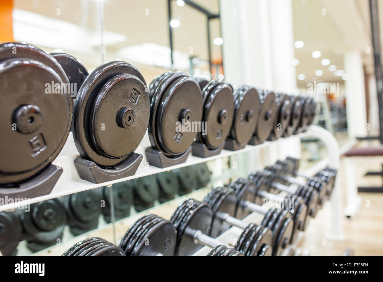 Black dumbbell in fitness center room for background . Stock Photo