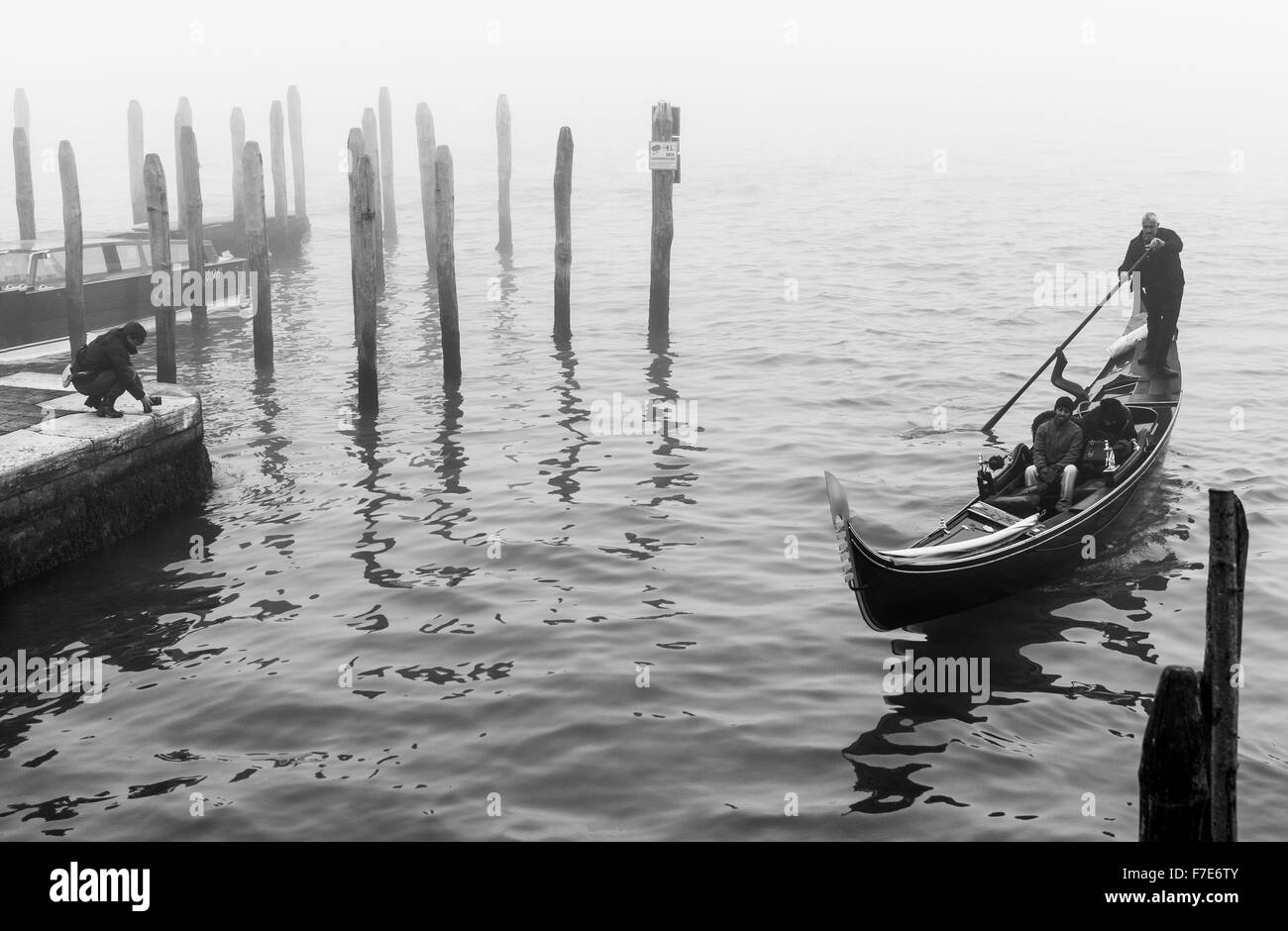 Italy, Venice, tourists in gondola near Riva Degli Schiavoni in a foggy day Stock Photo