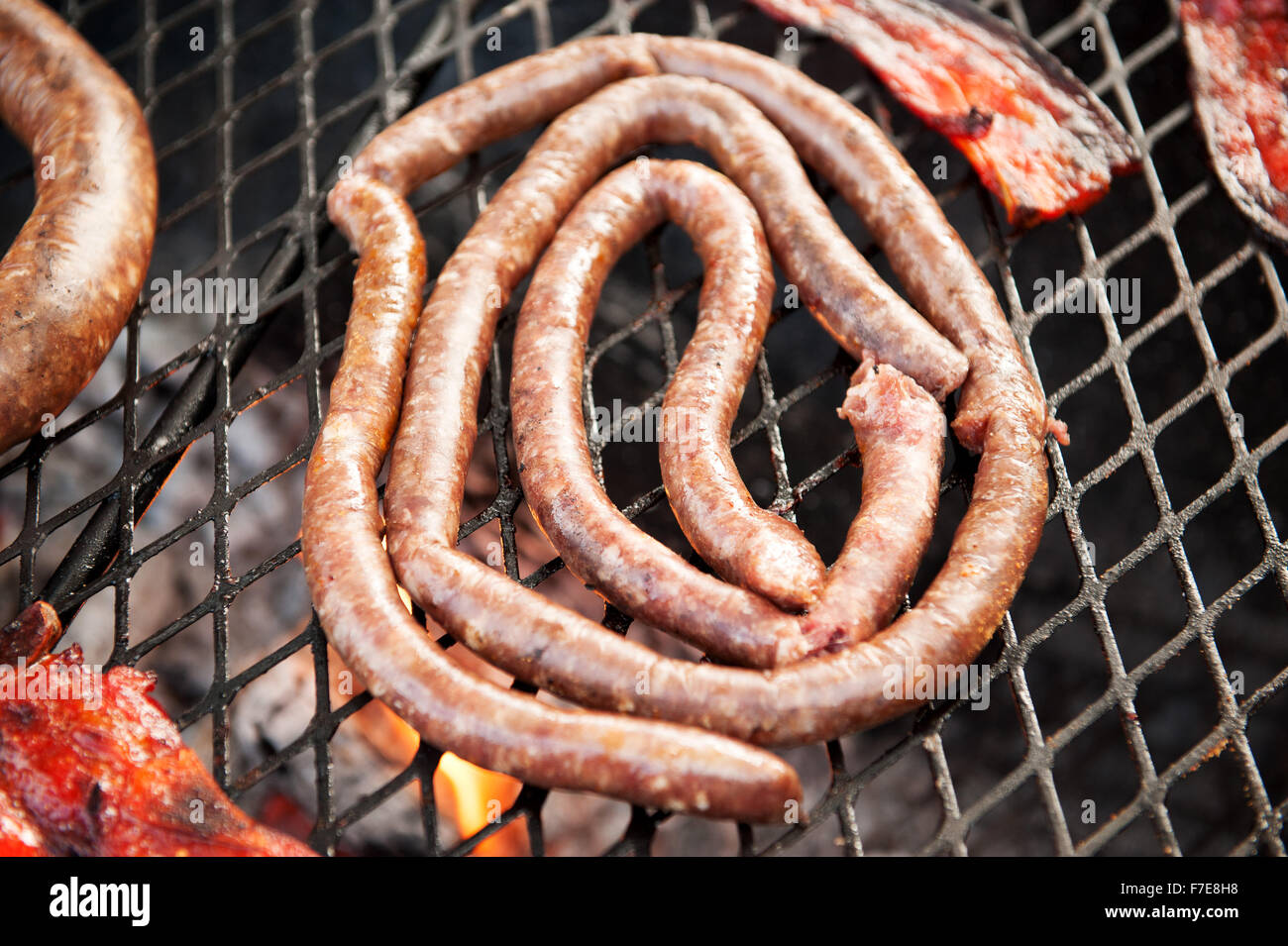 Traditional South African Boerwors sausage cooks on a Braai, or South