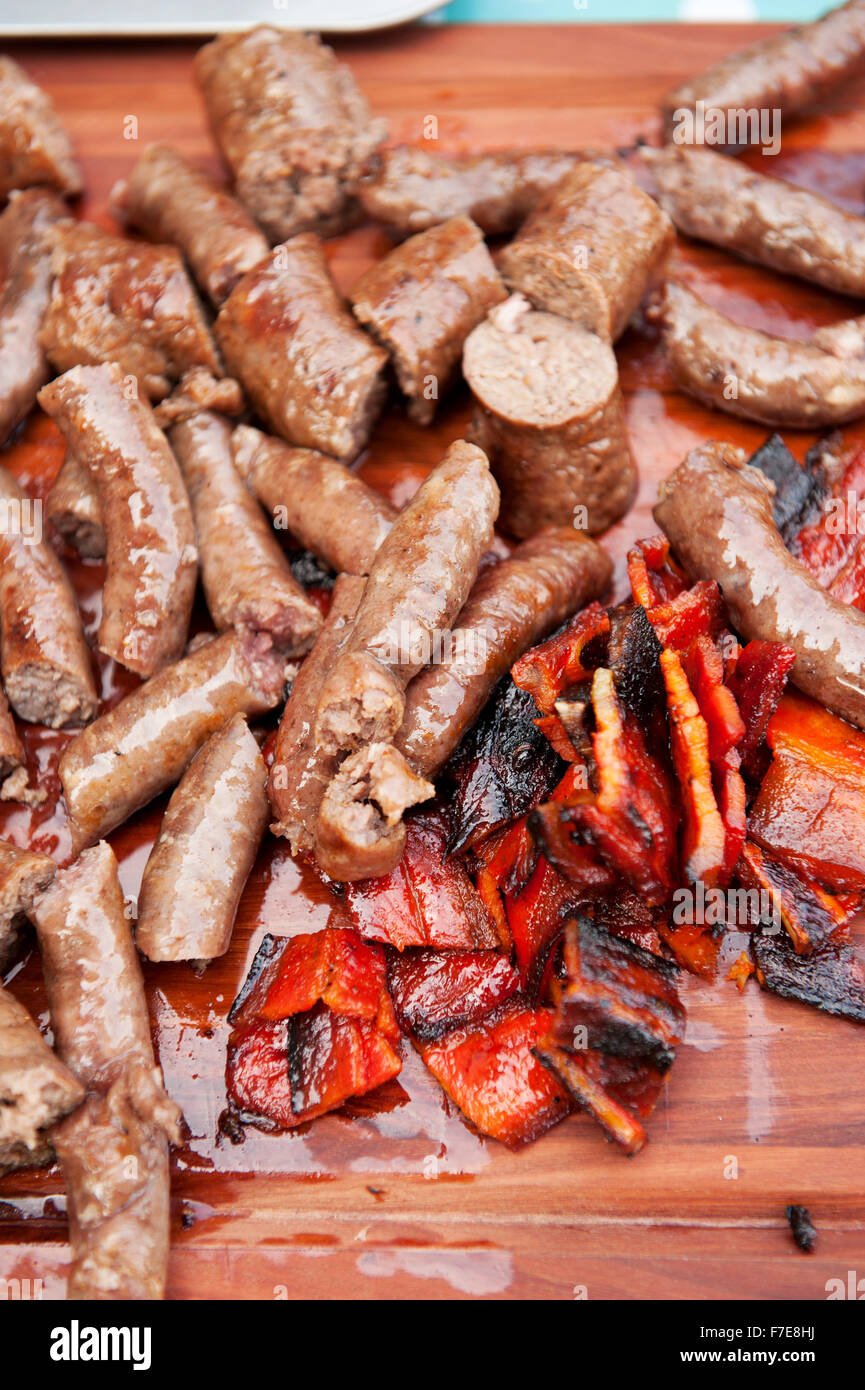 Traditional South African Boerwors sausage cooks on a Braai, or South African barbecue..  Durban South Africa. Stock Photo