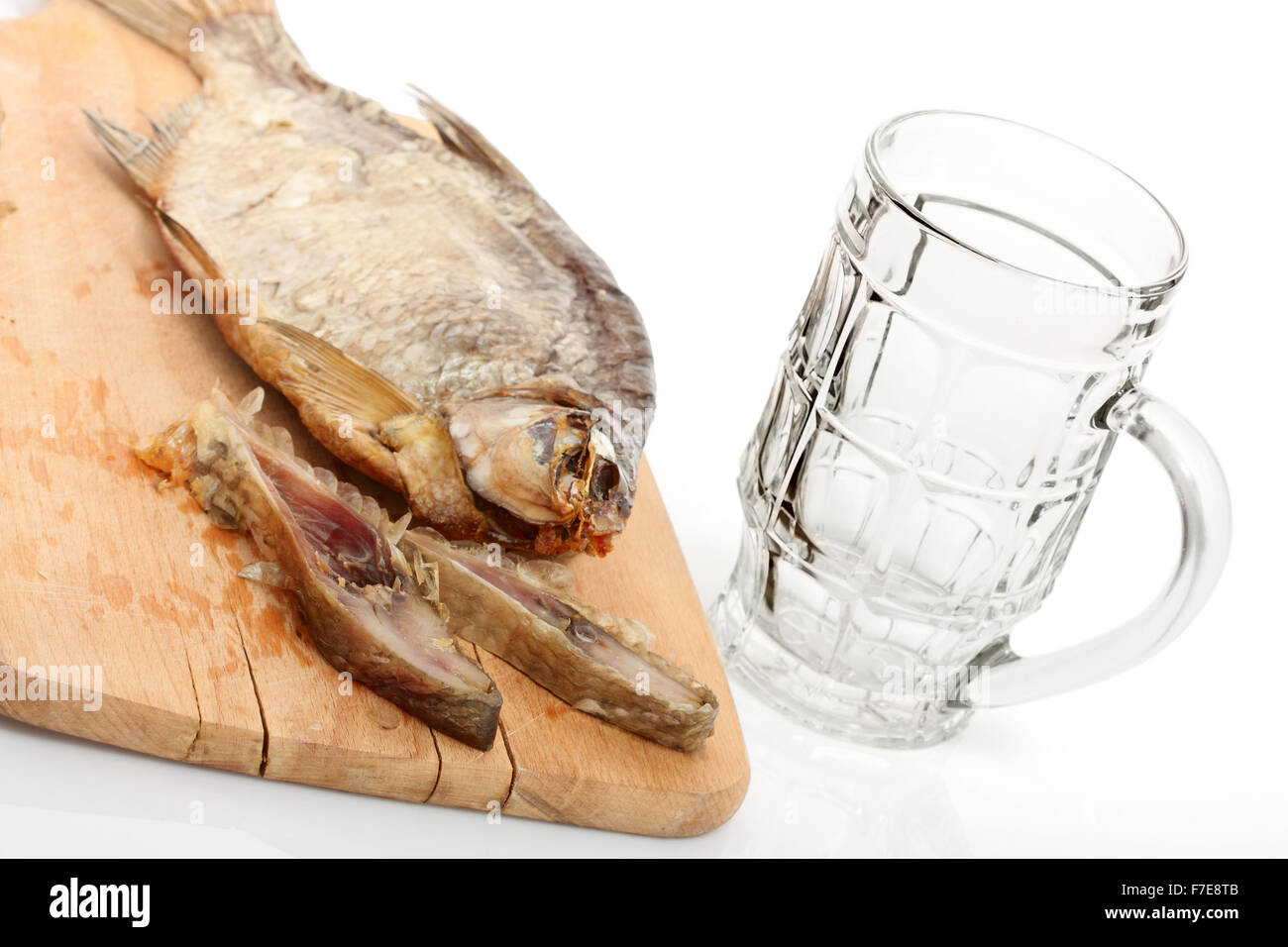 Sun Dried Bream and Empty Beer Mug. Isolated with clipping path. Stock Photo