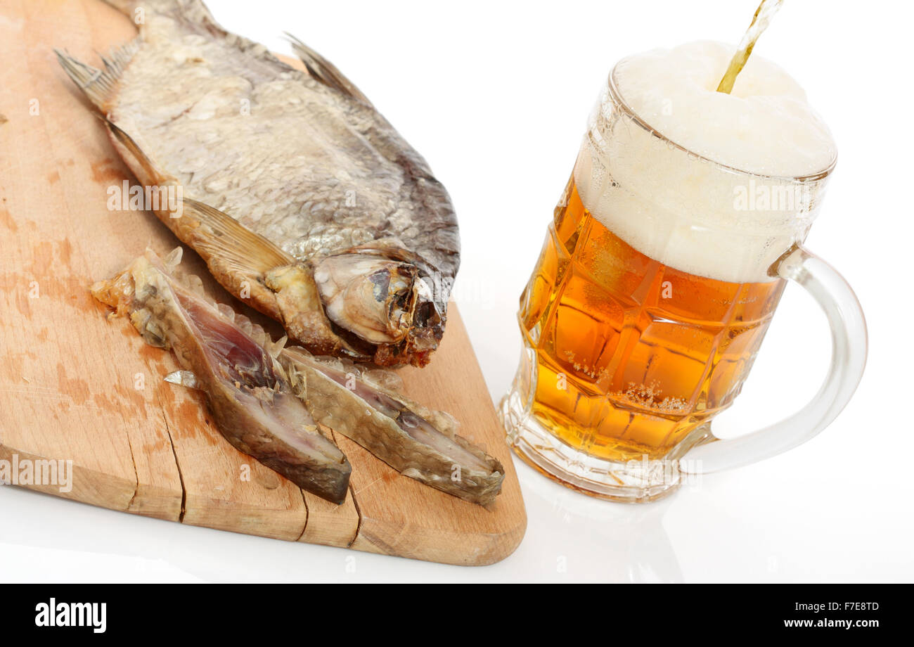 Sun Dried Bream and Pouring Beer. Isolated with clipping path. Stock Photo
