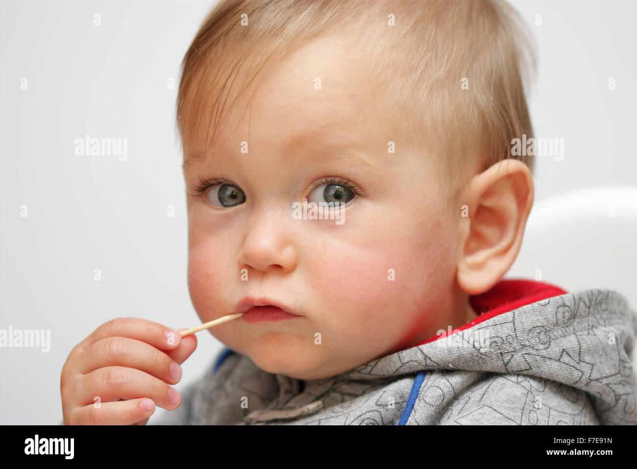 Portrait of Baby boy with toothpick in mouth Stock Photo Alamy