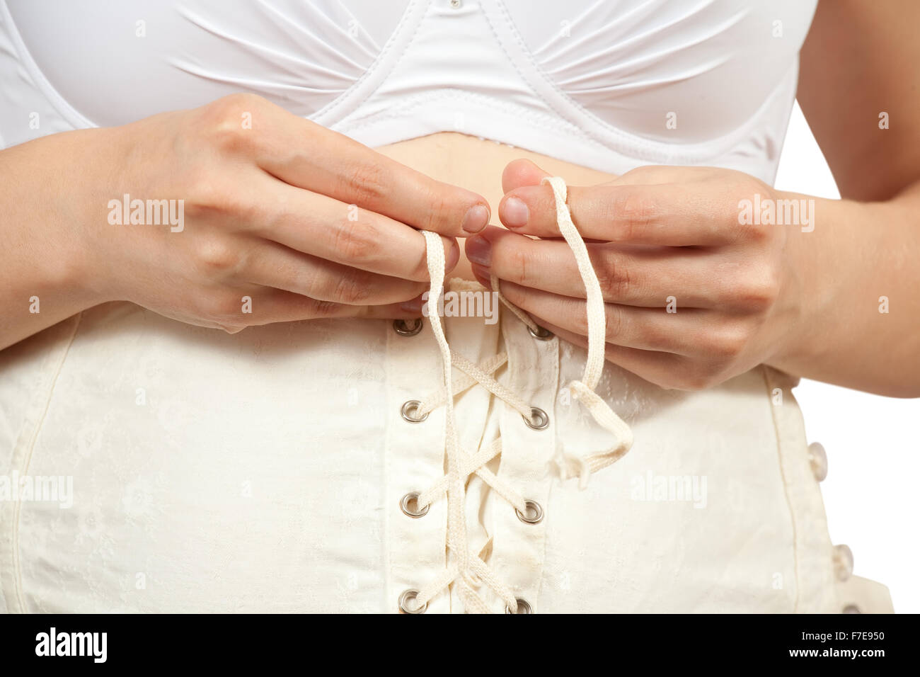 Closeup of pregnant woman dressing body belt. Isolated over white Stock Photo