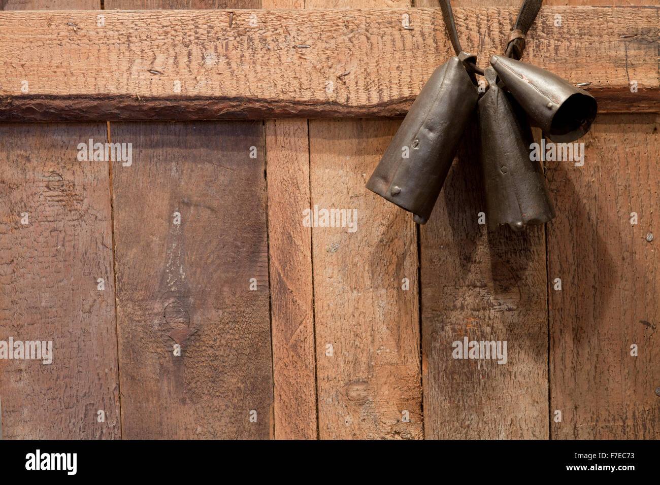 pastoral bells on brown wooden texture or rustic background Stock Photo