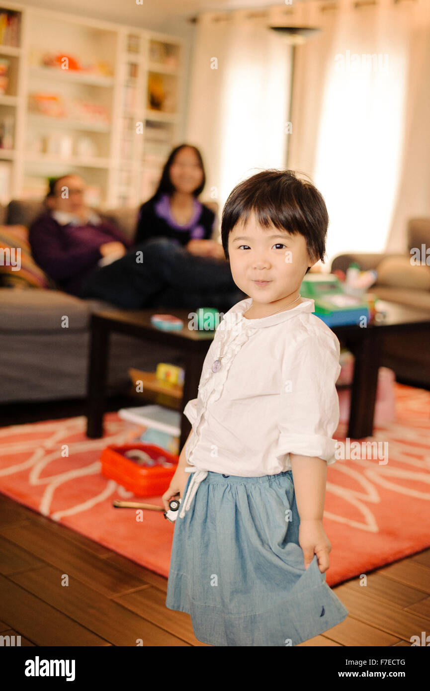 USA, Portrait of girl (2-3) smiling in living room Stock Photo