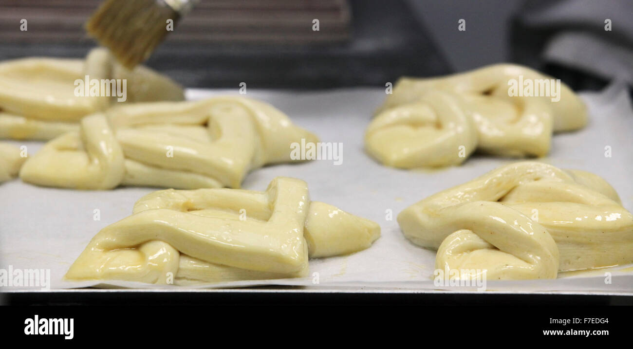 The shaped pastries are allowed to leaven before baking, glazing has been applied Photographed at a boutique bakery Stock Photo