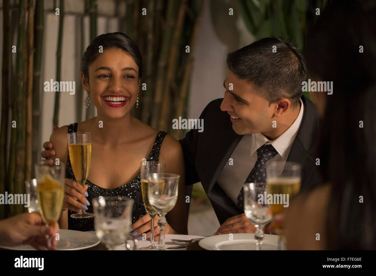 Singapore, Man and woman laughing at dinner with friends Stock Photo ...