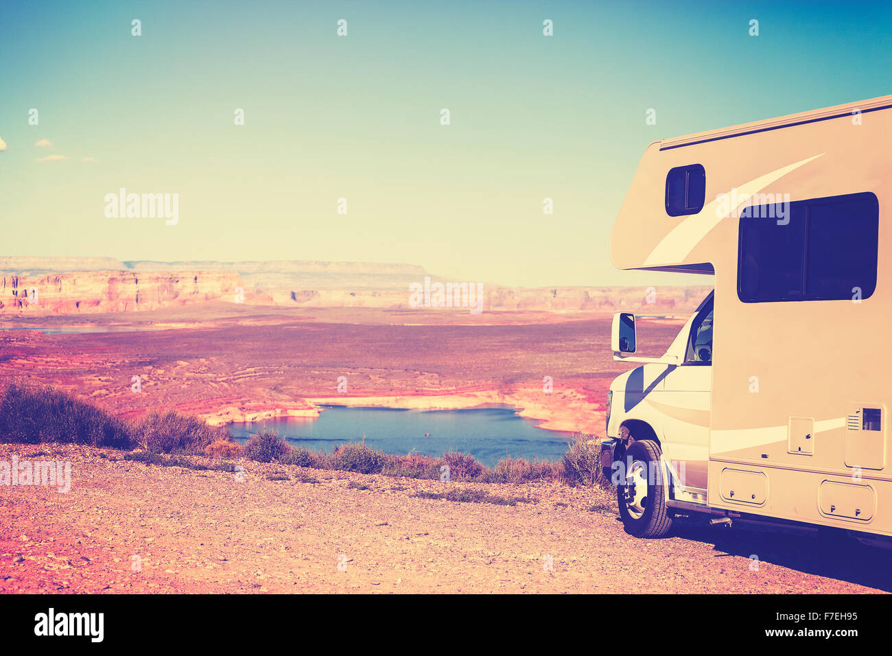 Vintage toned RV (camper) parked by canyon, family vacation concept, Lake Powell, USA. Stock Photo