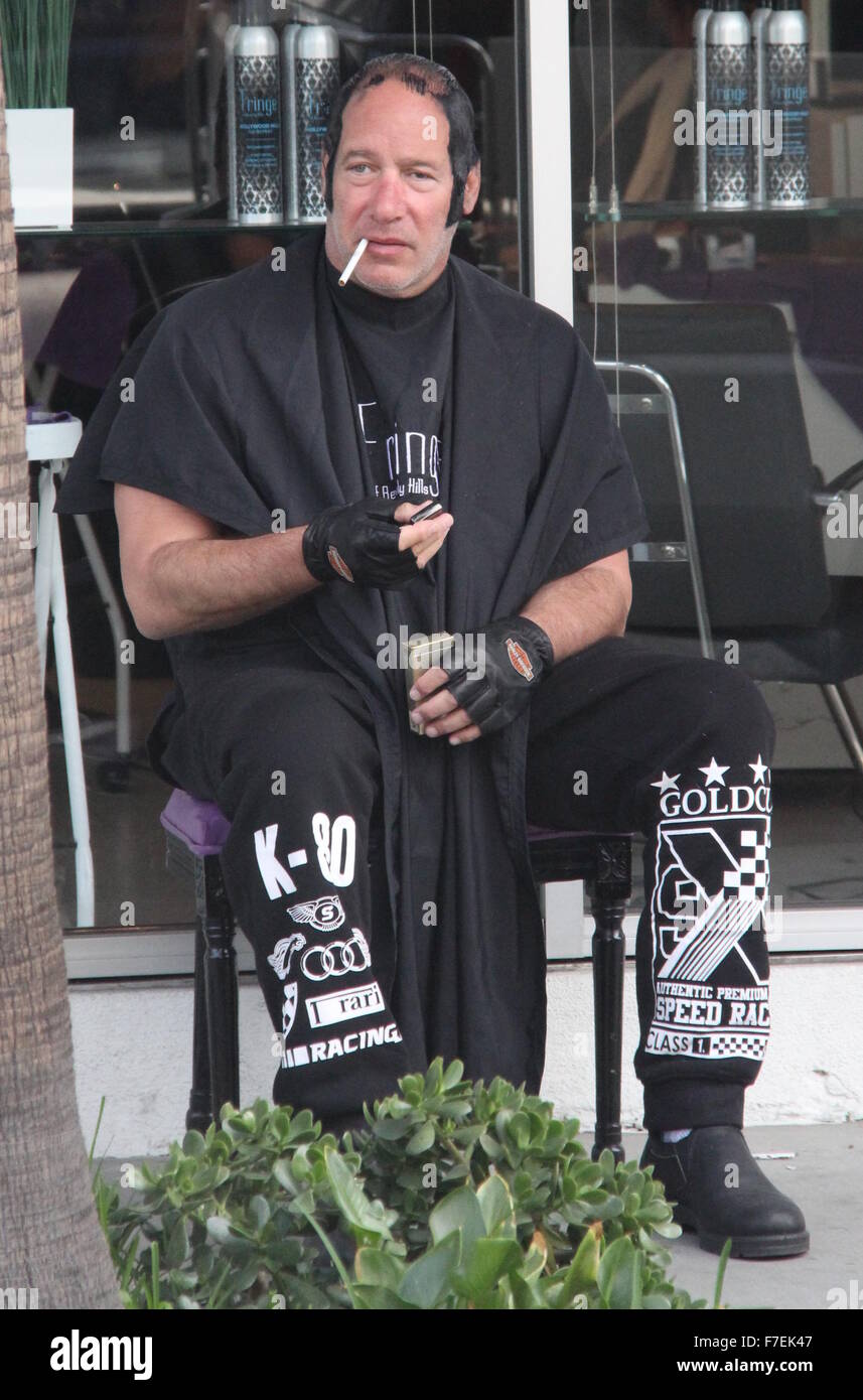 Andrew Dice Clay sports a bizarre hairdo as he's spotted lighting up a