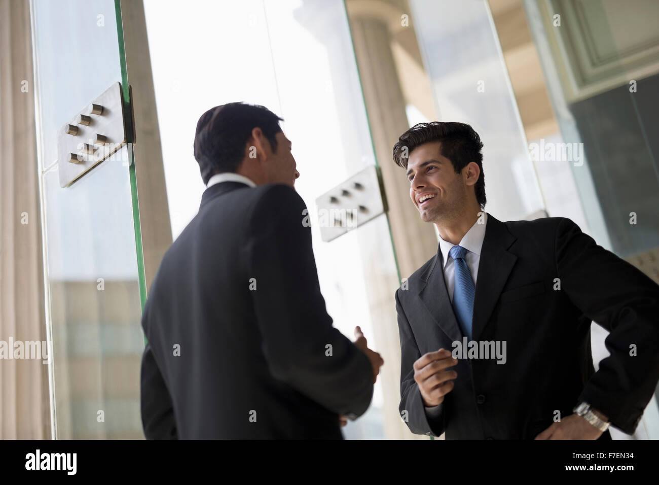 India, Two businessmen in suits talking Stock Photo - Alamy