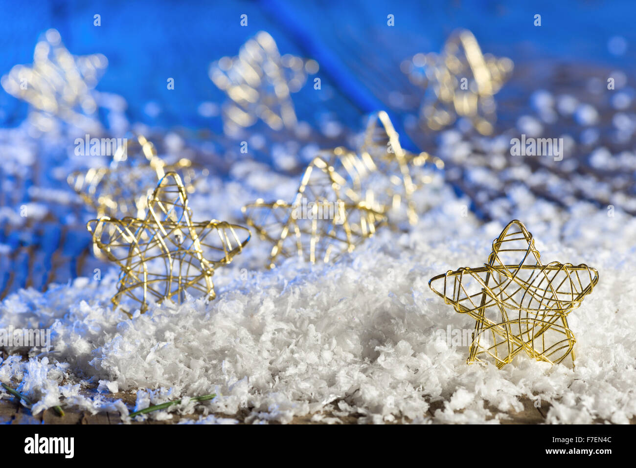 Christmas stars in the snow on the blue background Stock Photo - Alamy