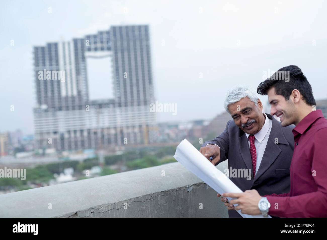 India, Architects and client discussing building plans Stock Photo - Alamy