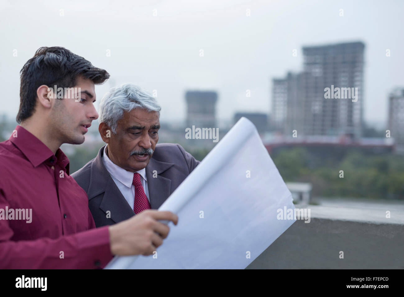 India, Architects and client discussing building plans Stock Photo - Alamy