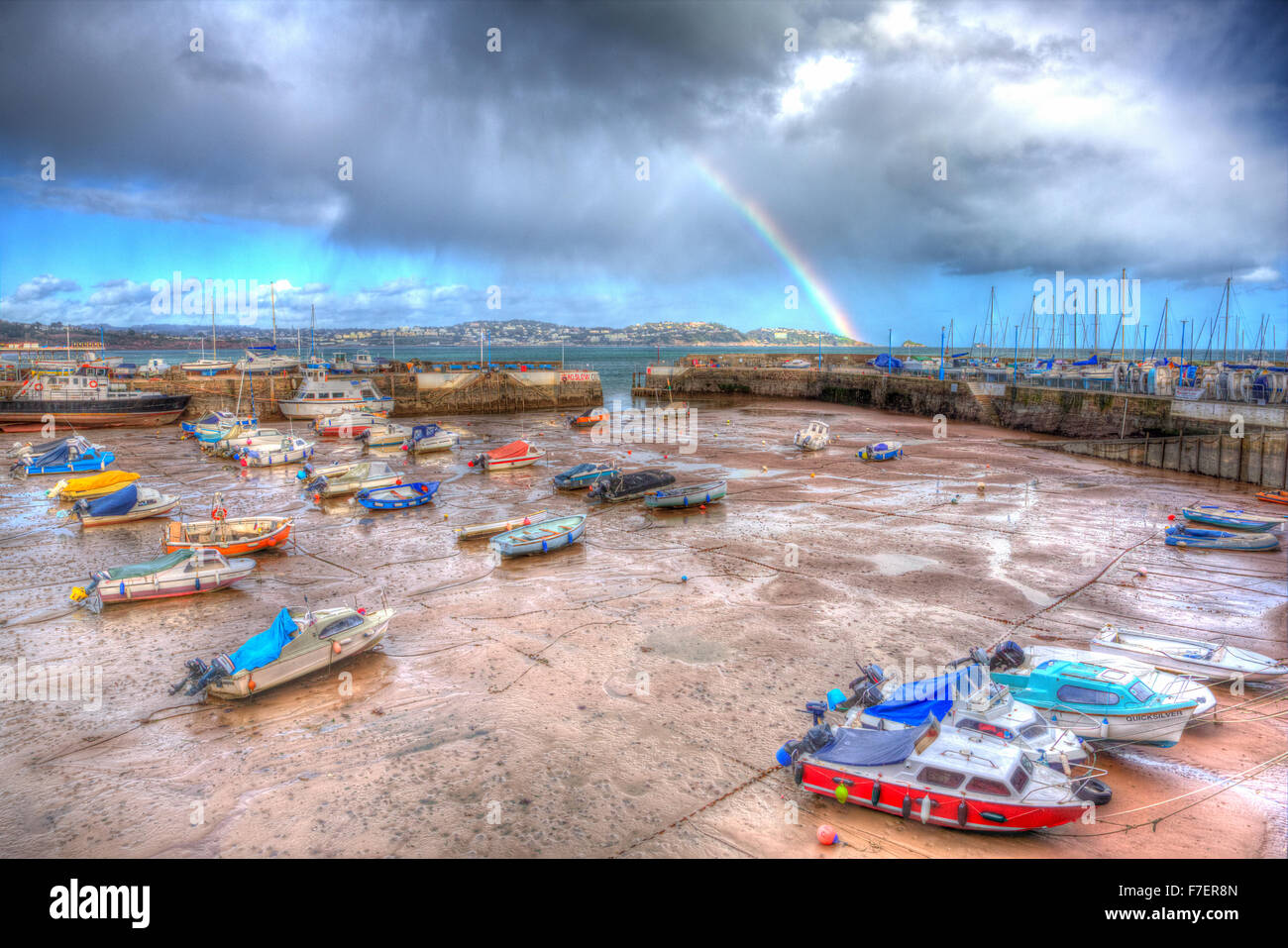 Rainbow English harbour paignton Devon England uk in colourful HDR with boats at low tide and view to Torquay Stock Photo