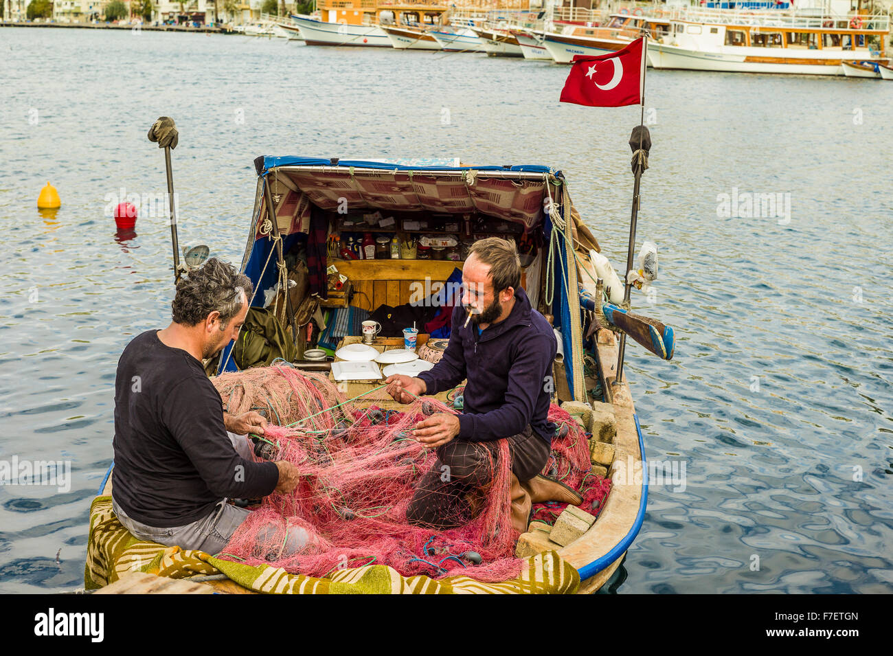 Fishermen mending nets Stock Photo