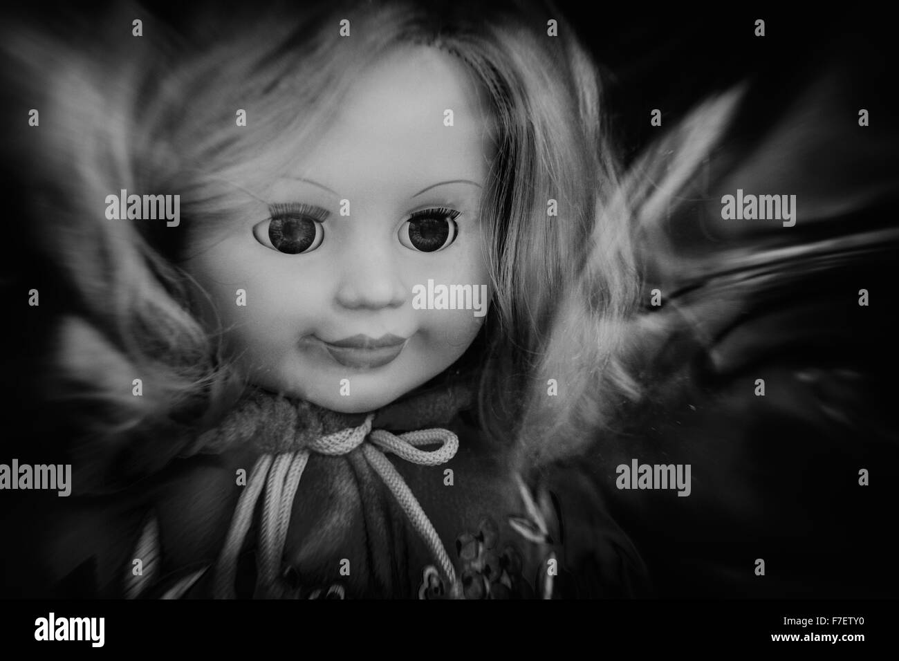 Closeup photograph of a single childs 's dolls face with nobody in the background Stock Photo