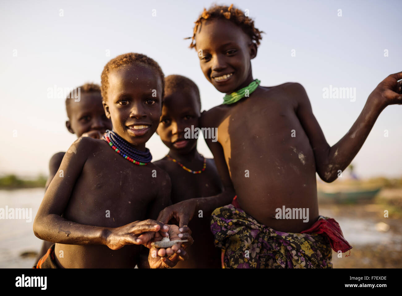Children fishing on the shore of Turkana Lake, Dassanech Tribe, Omo Valley, Ethiopia Stock Photo