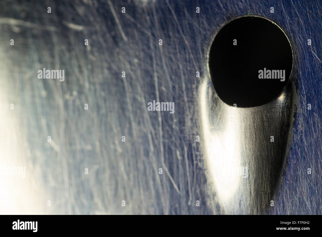 Close-up macro shot of a worn and used metal kitchen cheese or food grater Stock Photo