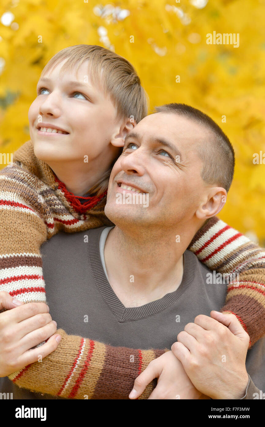 Father and son in autumn park Stock Photo - Alamy