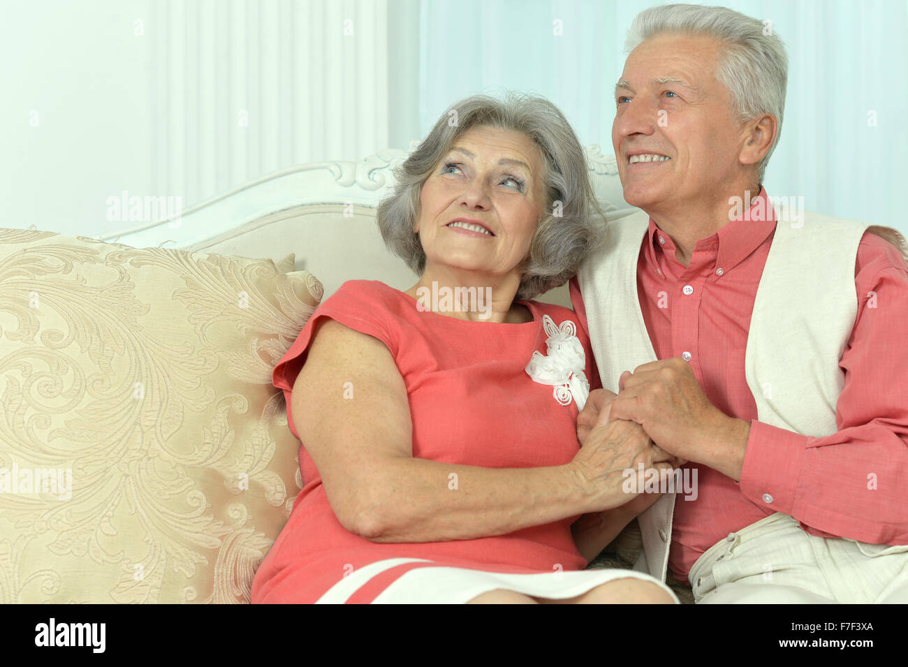 Elderly people sitting on couch Stock Photo