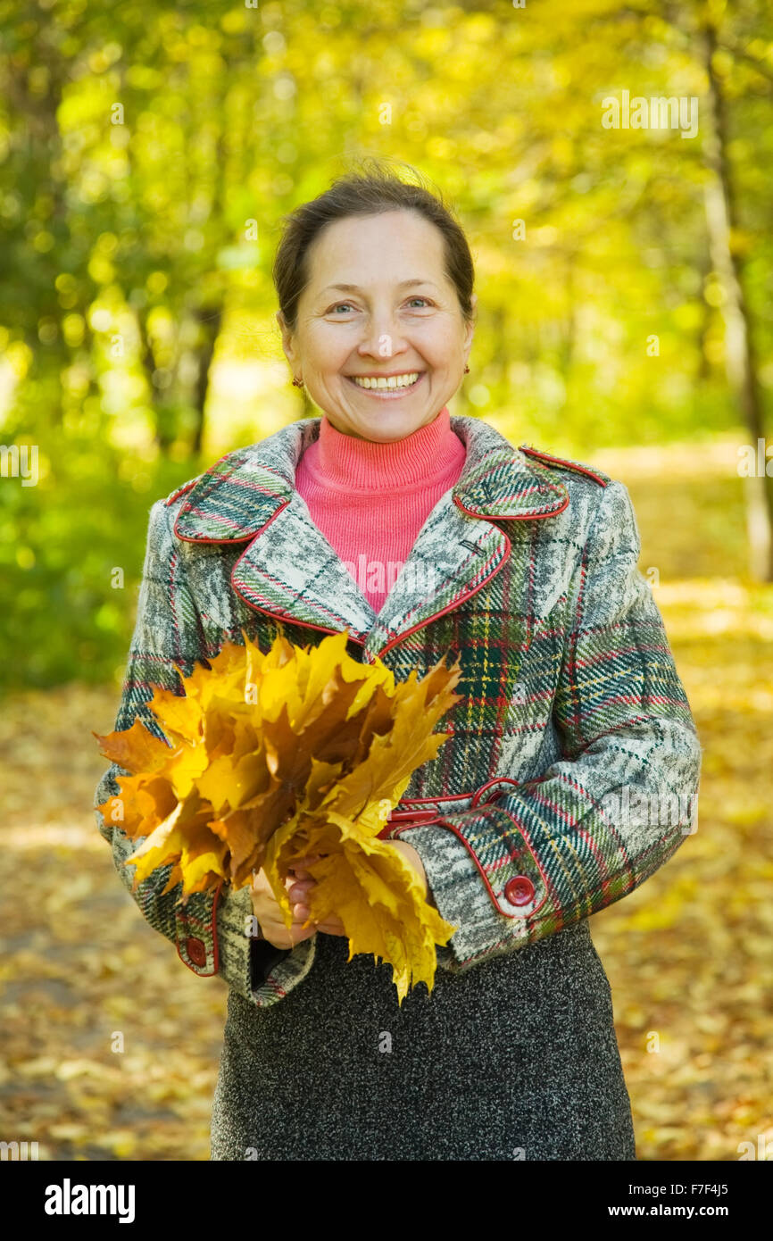 Portrait of laughing mature woman in autumn park Stock Photo - Alamy