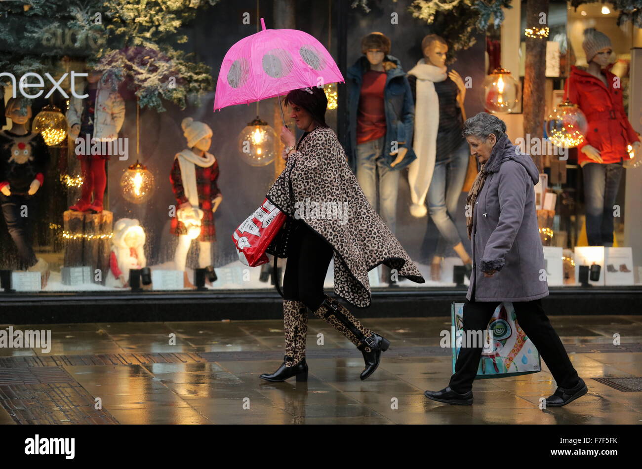 Swansea UK. Monday 30 November 2015  A female shopper with an umbrella in Oxford Street, Swansea, south Wales, as strong winds and heavy rain has been affecting most parts on the UK. Credit:  D Legakis/Alamy Live News Stock Photo