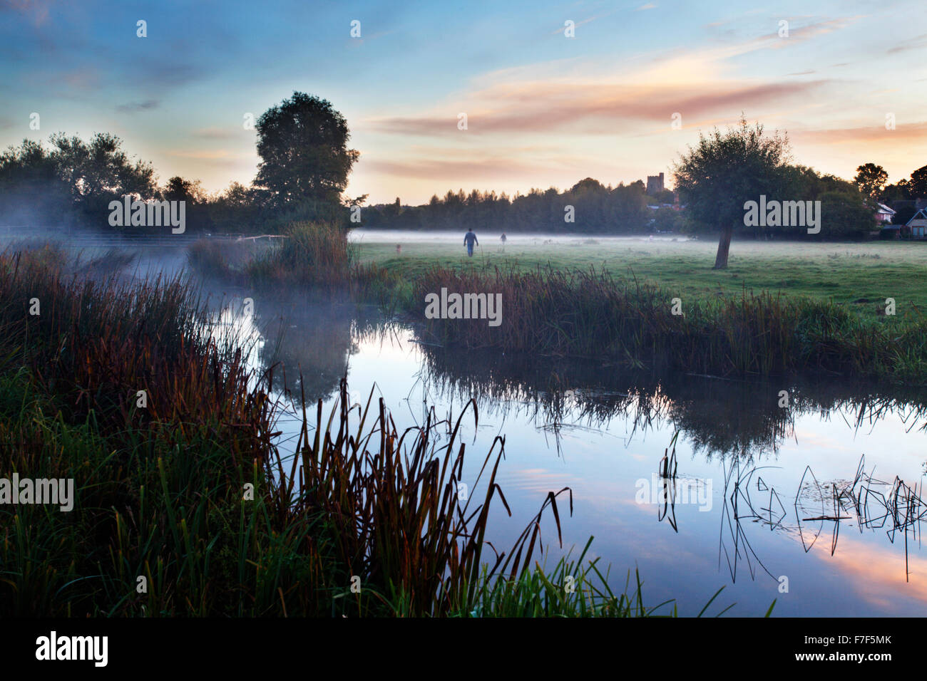 Dog Walkers on Sudbury Water Meadows at Dawn Sudbury Suffolk England