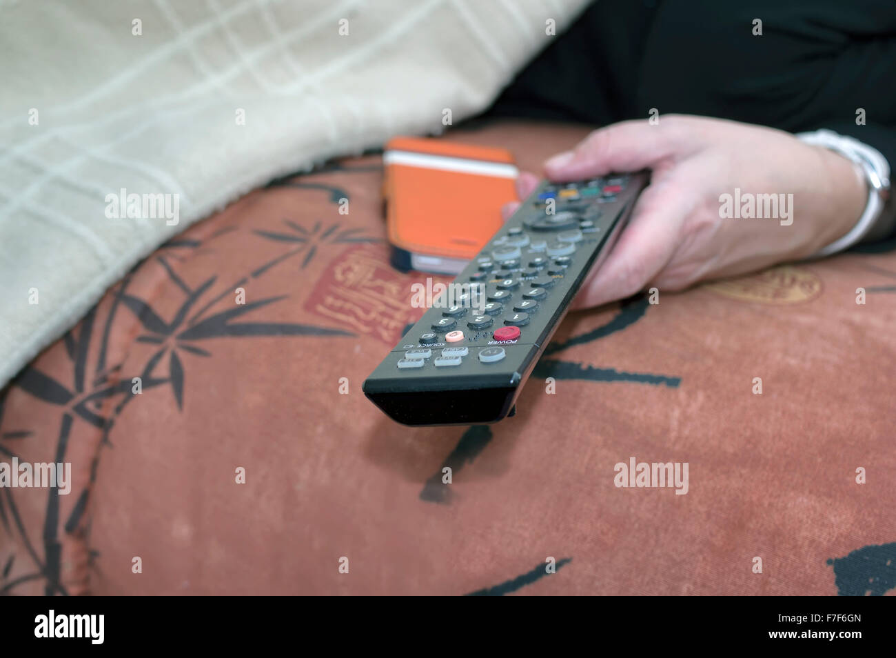 Hand with remote control Stock Photo
