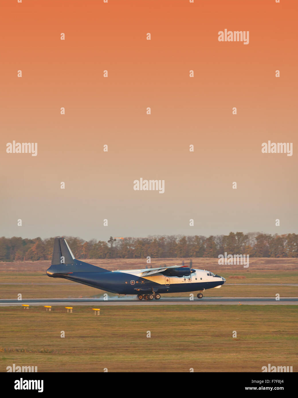 Old turboprop cargo plane landing on sunset Stock Photo - Alamy