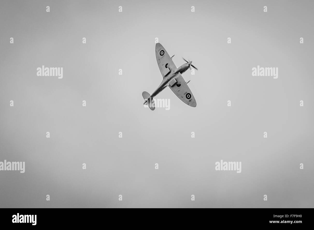 The undercarriage of a lone Spitfire aeroplane in flight in mono/greyscale Stock Photo