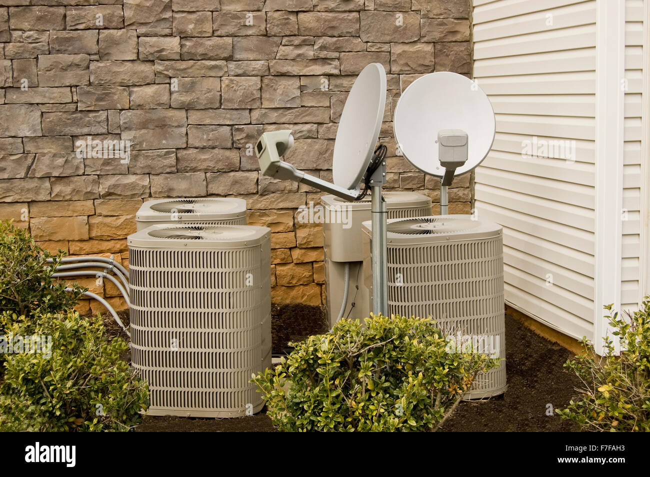 Air Conditioning Compressors and Satellite Dishes Stock Photo