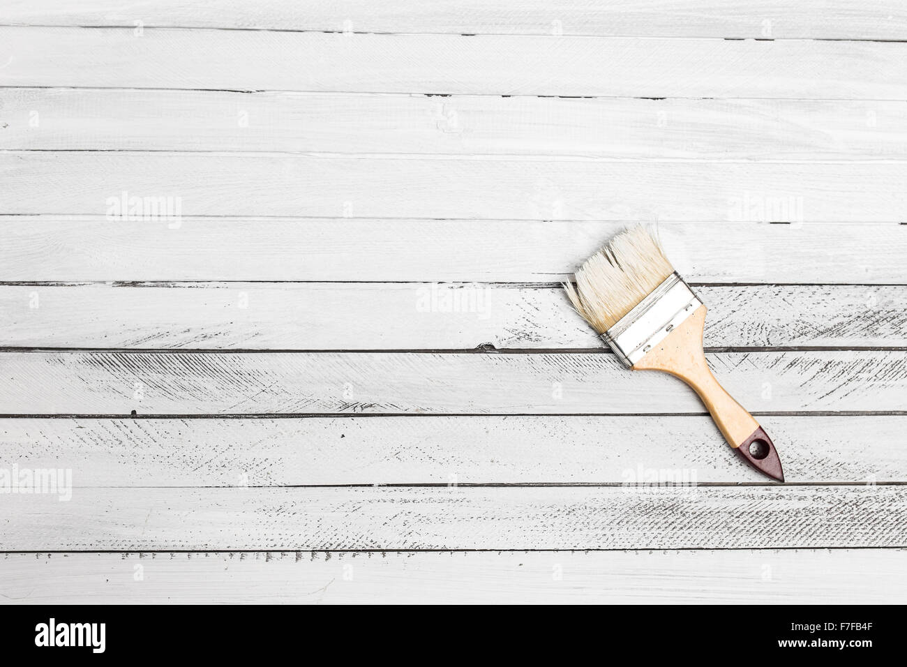 Painting a wooden floor using paintbrush Stock Photo Alamy