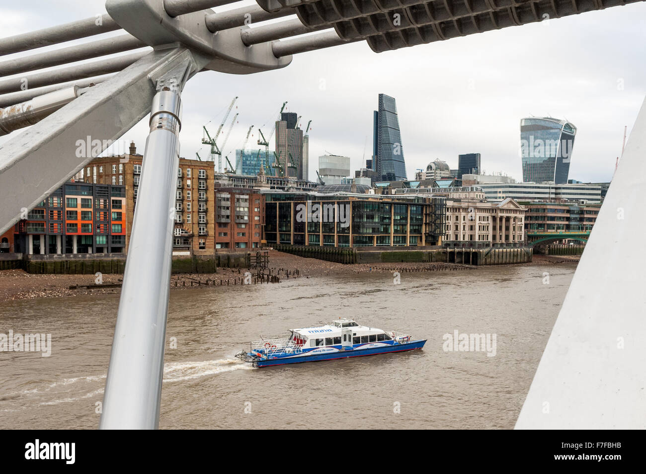 The view from The Millennium Bridge London looking over The River Thames towards the shore line. Stock Photo