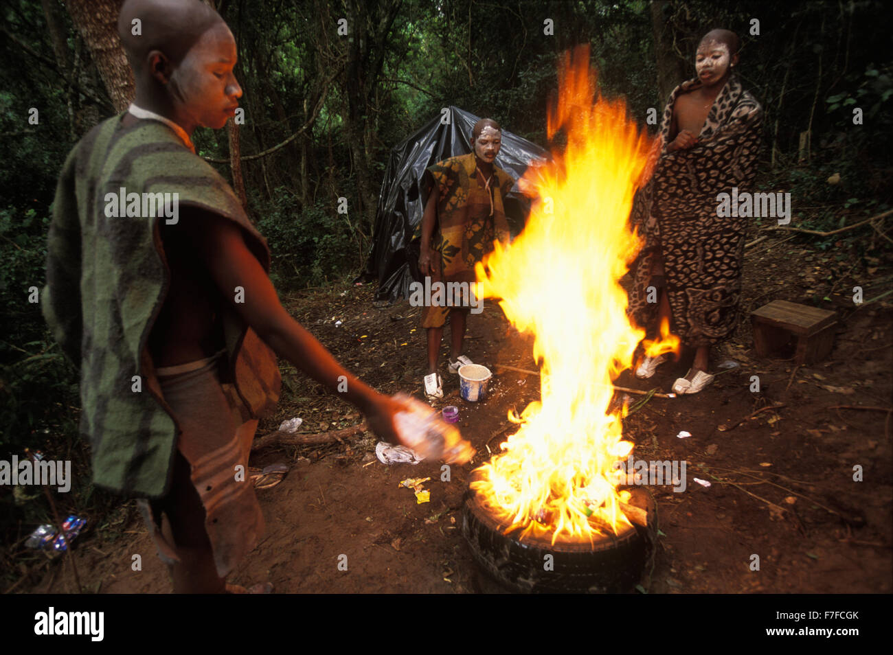 Xhosa male initiates light a fire around which they will dance before returning home after a month in seclusion Stock Photo