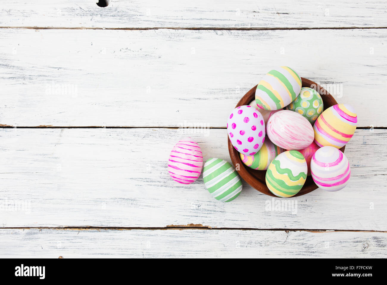 Easter eggs painted in pastel colors on white wooden background. Easter ...