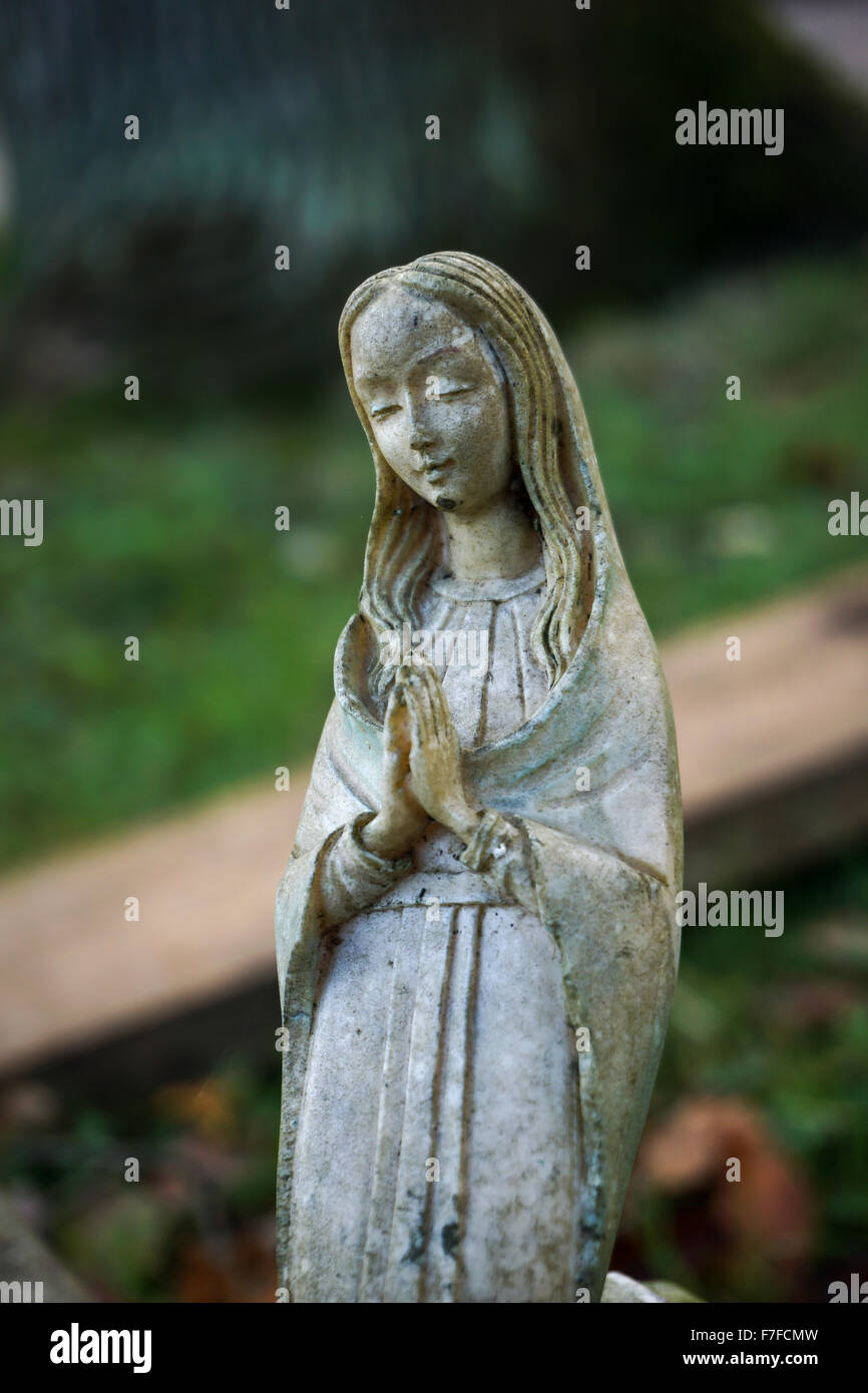 Small statue of Mary at a graveyard Stock Photo Alamy