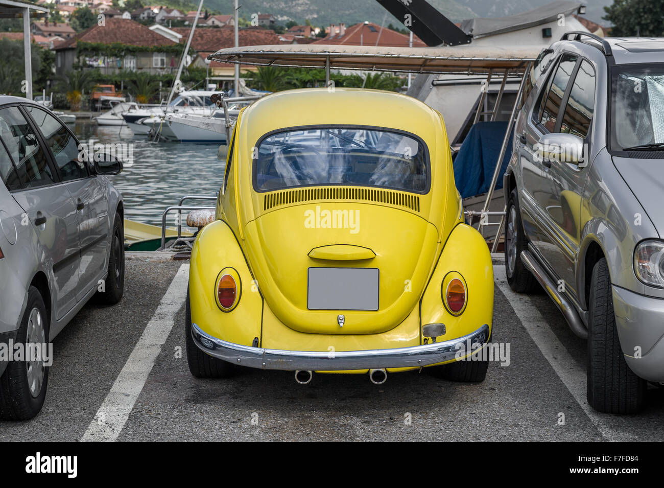 Yellow retro car at yacht marina Stock Photo