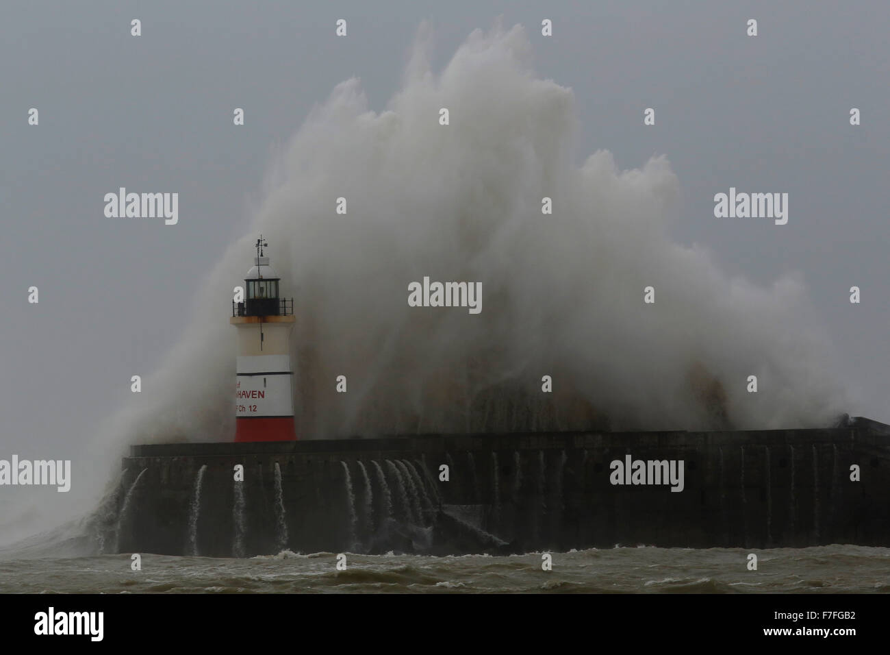 Newhaven, UK. 30th Nov, 2015. Giant waves crash against the Newhaven harbour lighthouse as strong winds continue in the wake of storm Clodagh in East Sussex coast, UK Monday November 30, 2015.  Regions of Britain continued to be subject to yellow weather warnings for gusting winds upto 60mph. Credit:  Luke MacGregor/Alamy Live News Stock Photo
