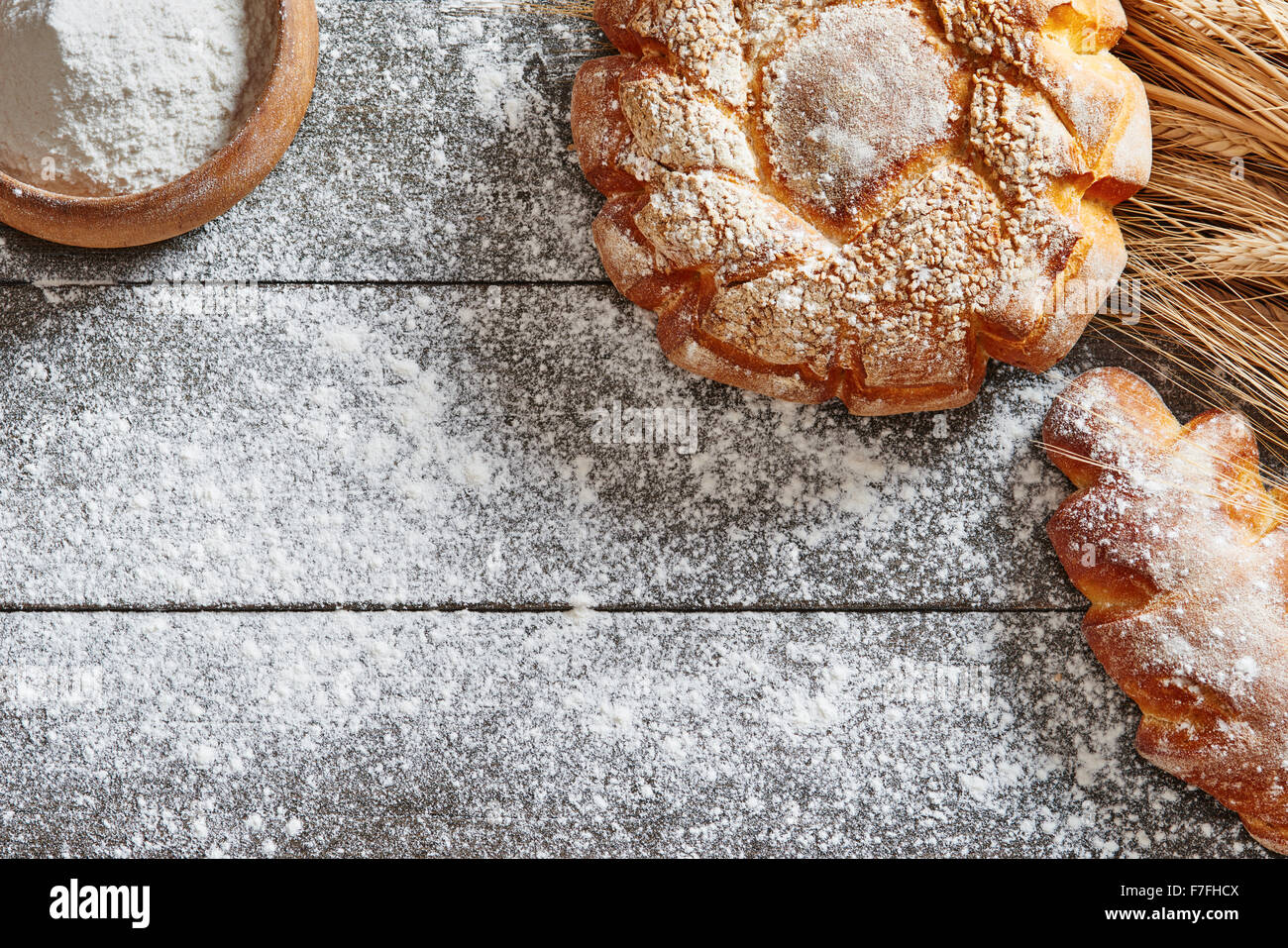 Bread and wheat on the wooden table floured Stock Photo - Alamy