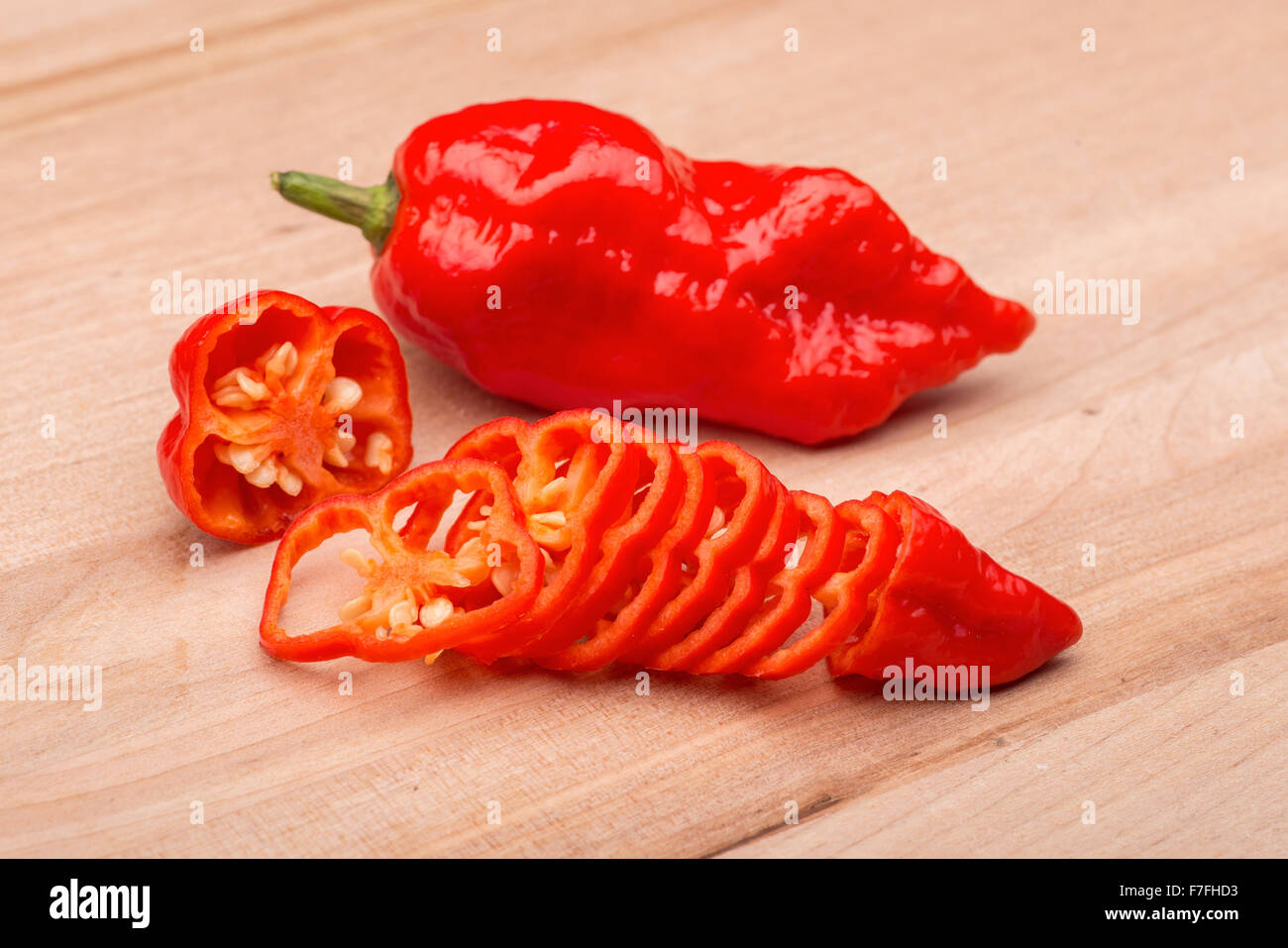 A sliced super hot ghost chili on a wooden cutting board Stock Photo - Alamy
