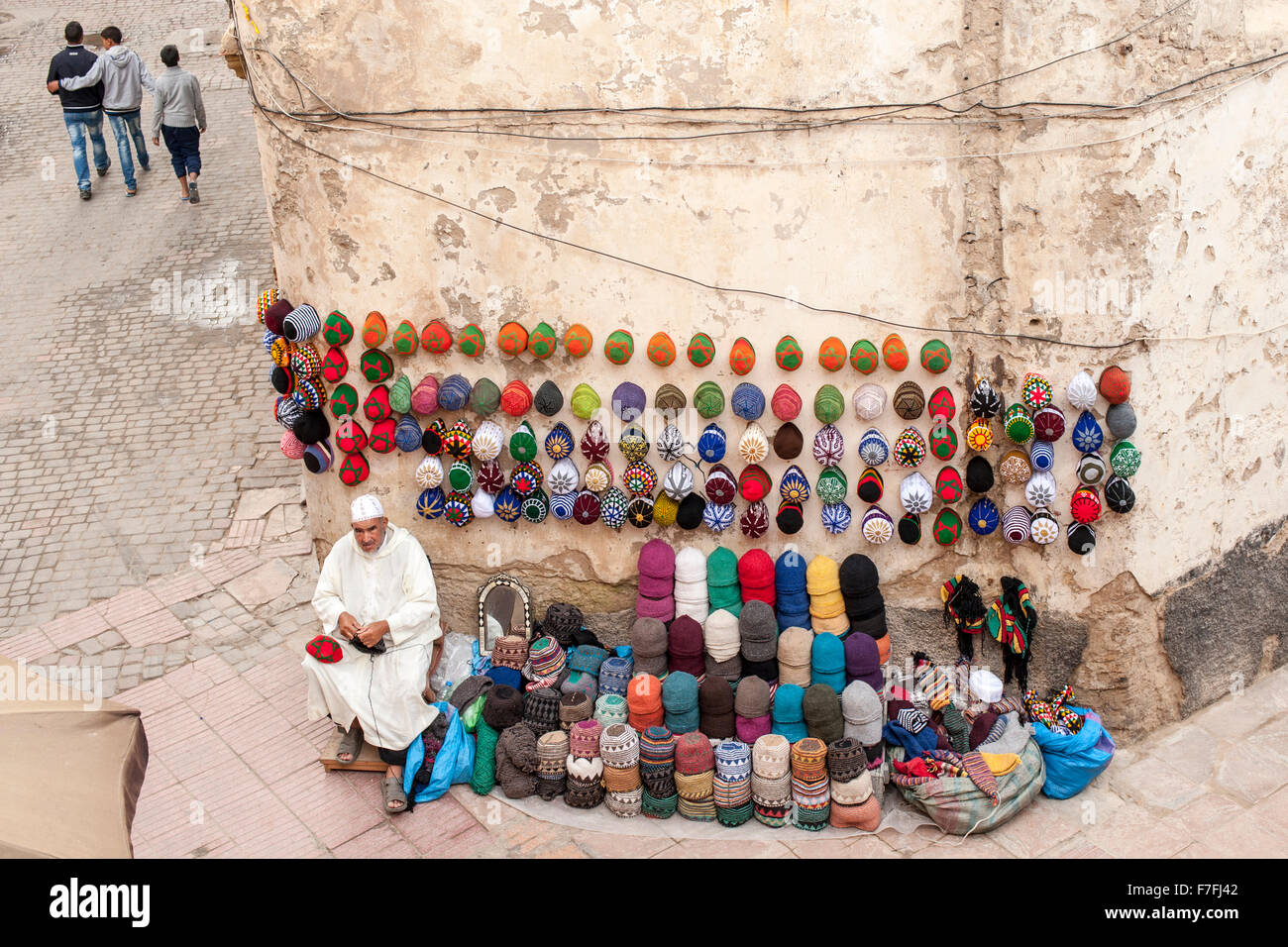 Kufi/fez hat vendor in the old town medina in Essaouira, Morocco. Stock Photo