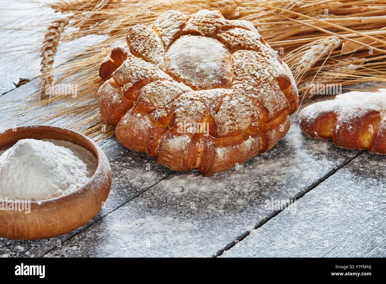 Bread and wheat on the wooden table floured Stock Photo - Alamy