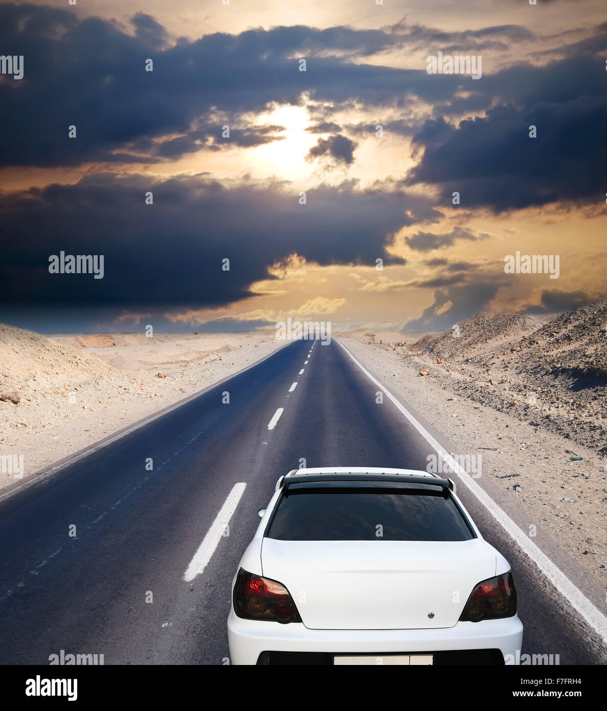 White car on desert road under blue sky Stock Photo - Alamy