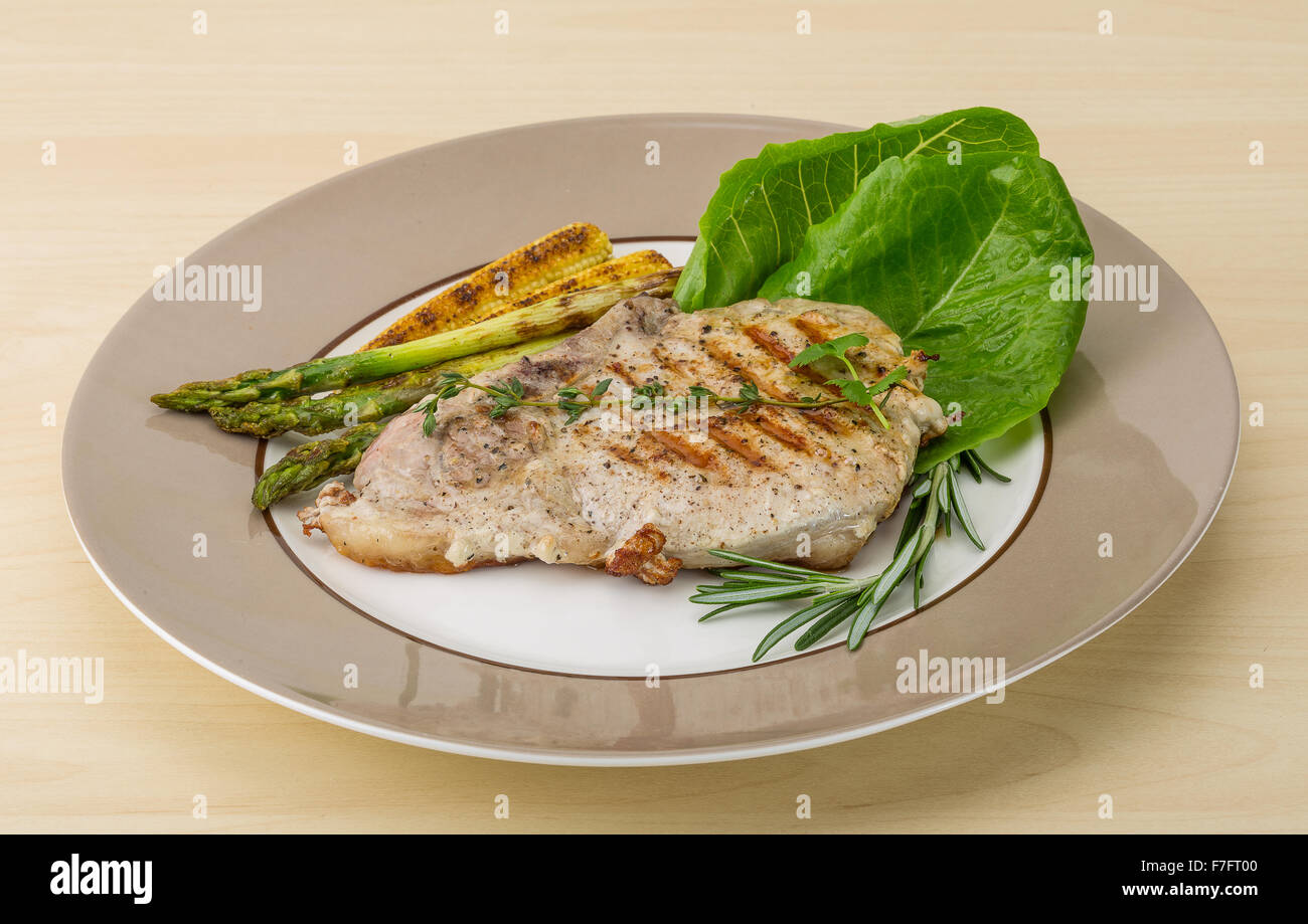 Pork steak with grilled asparagus and baby corn Stock Photo Alamy
